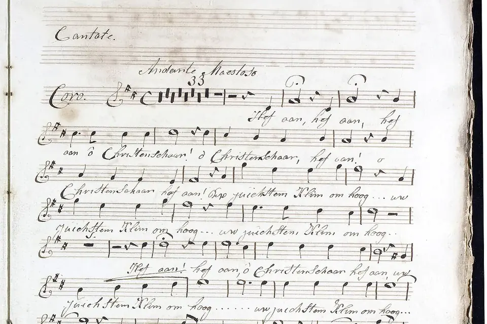 Page de manuscrit musical ancien, avec des portées écrites à l'encre et des paroles sous les notes